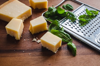 Parmesan cheese with a grater and fresh basil