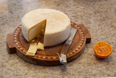 Wheel of parmesan cheese with a cut wedge