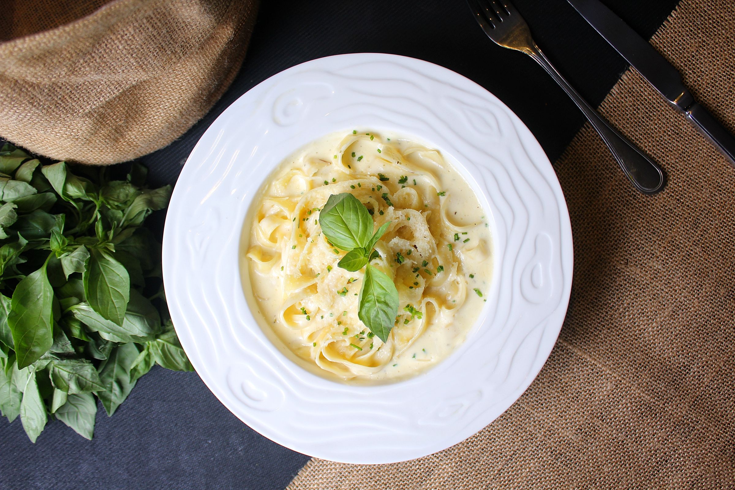 Creamy fettuccine alfredo pasta in a white bowl