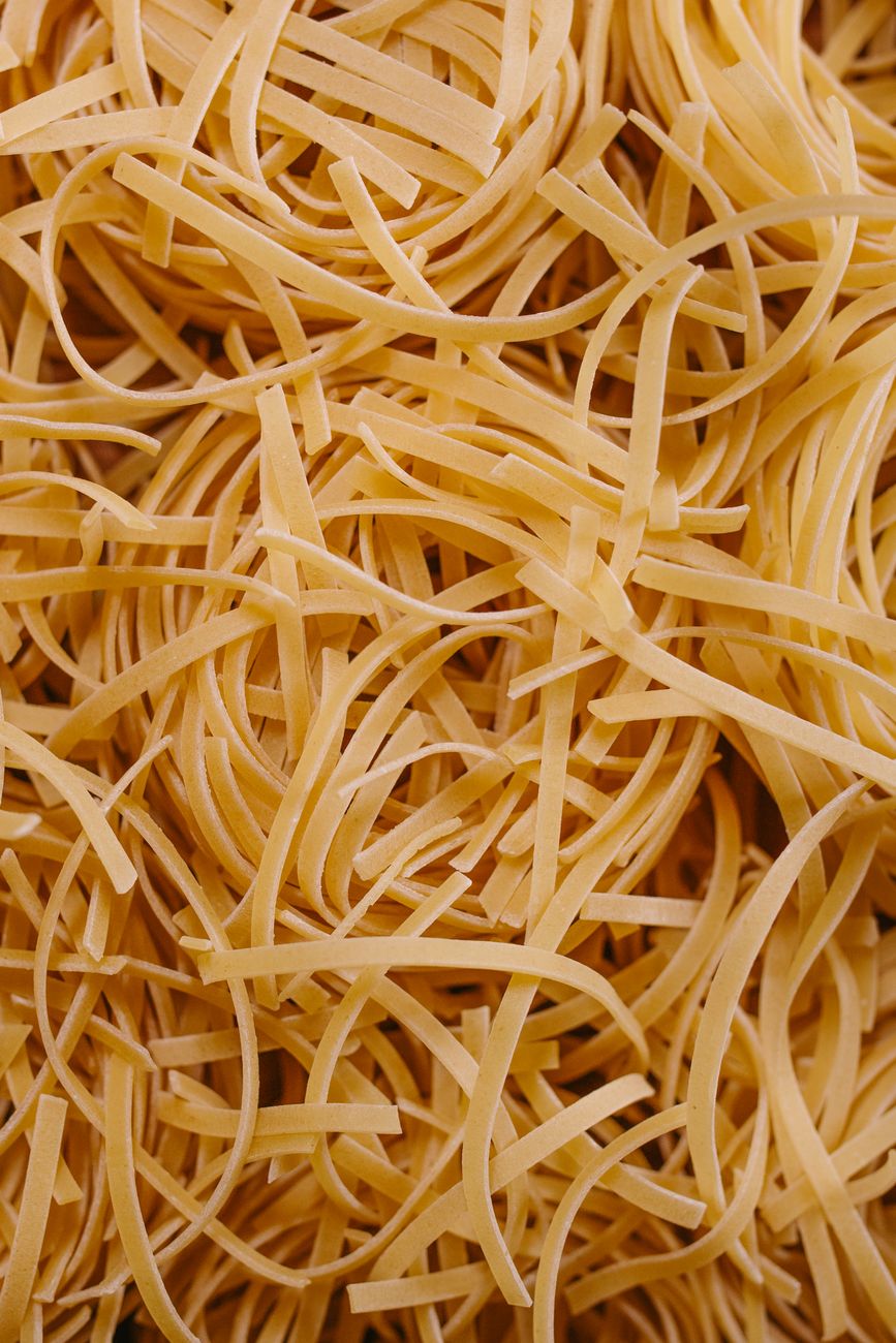 Raw uncooked linguini noodles close-up