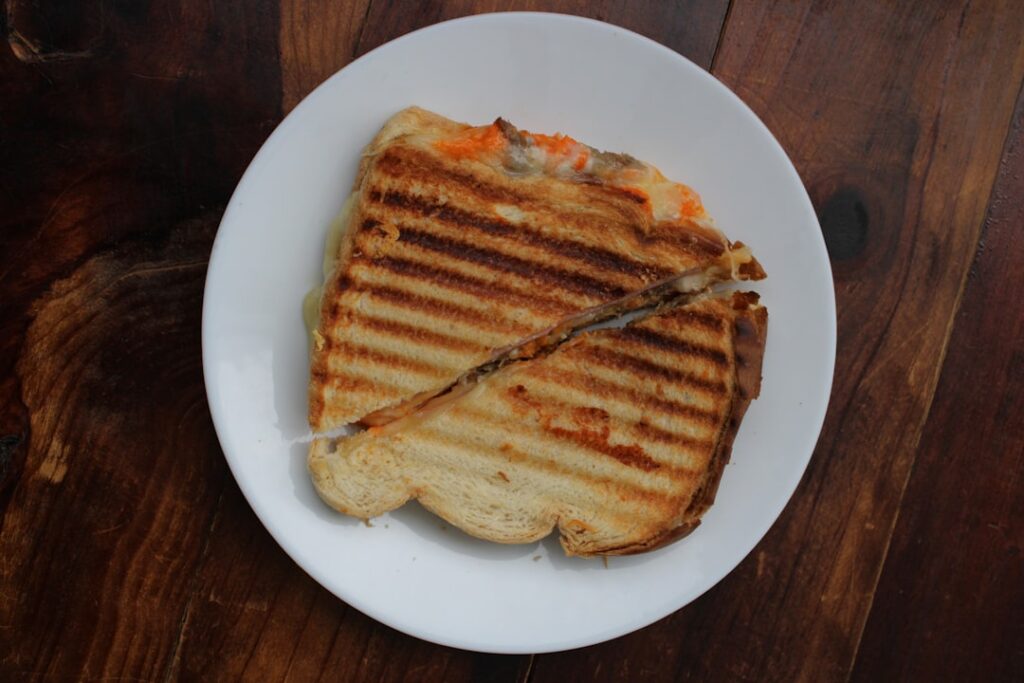 Grilled pepperoni cheesesteak panini with melted cheese