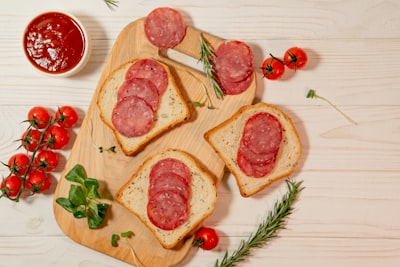 Open-faced deli sandwiches with cured meats, illustrating cheesesteak vs hoagie style