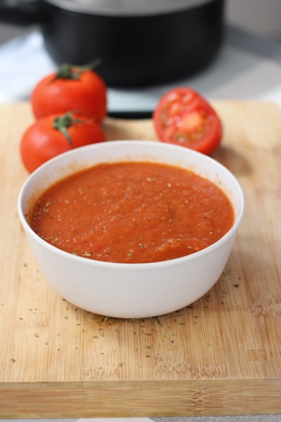 Bowl of marinara sauce with fresh tomatoes