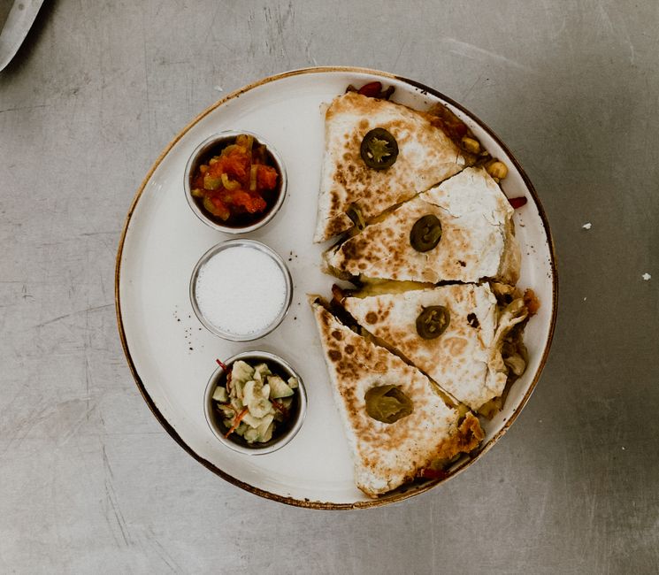 Quesadilla topped with jalapenos served with three dipping sauces