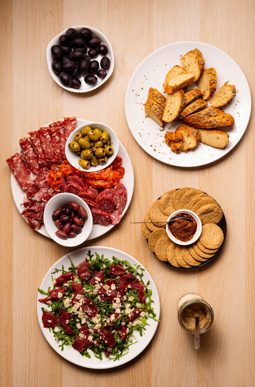 Assortment of cured meats and olives on a platter