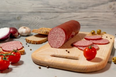 Sliced salami on a wooden cutting board