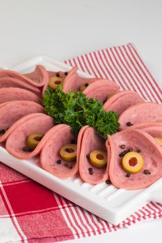Sliced cold cuts platter with olives and parsley