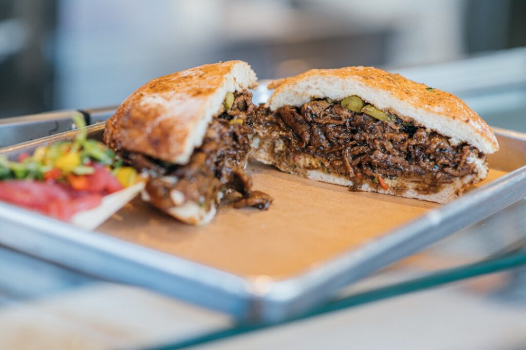 Sliced steak sandwich on a fresh roll