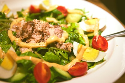 Tuna salad with greens and tomatoes on a plate