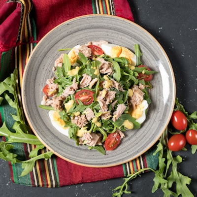 Tuna salad with arugula, tomatoes, and boiled egg