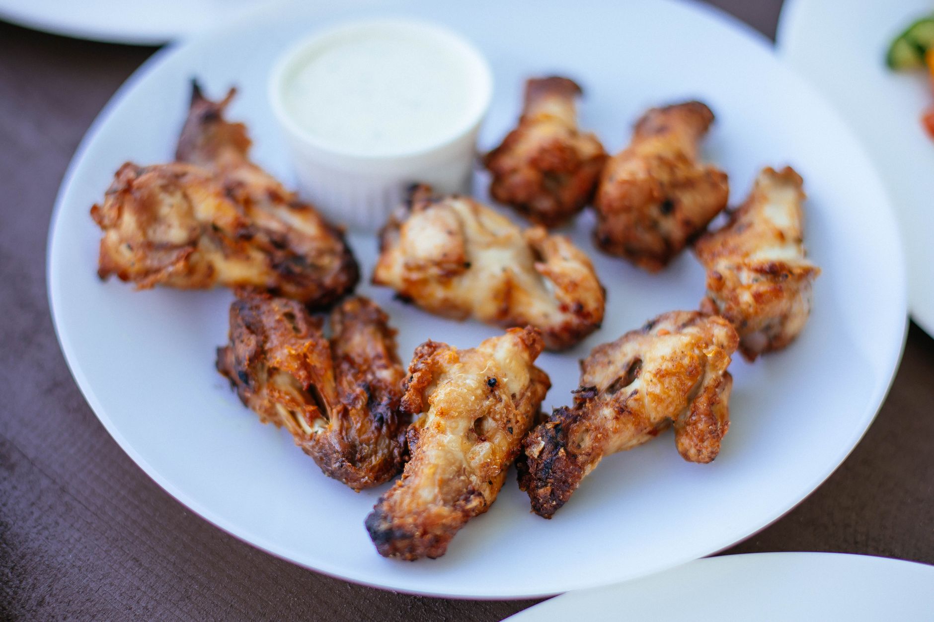 Plain crispy fried chicken wings on a white plate