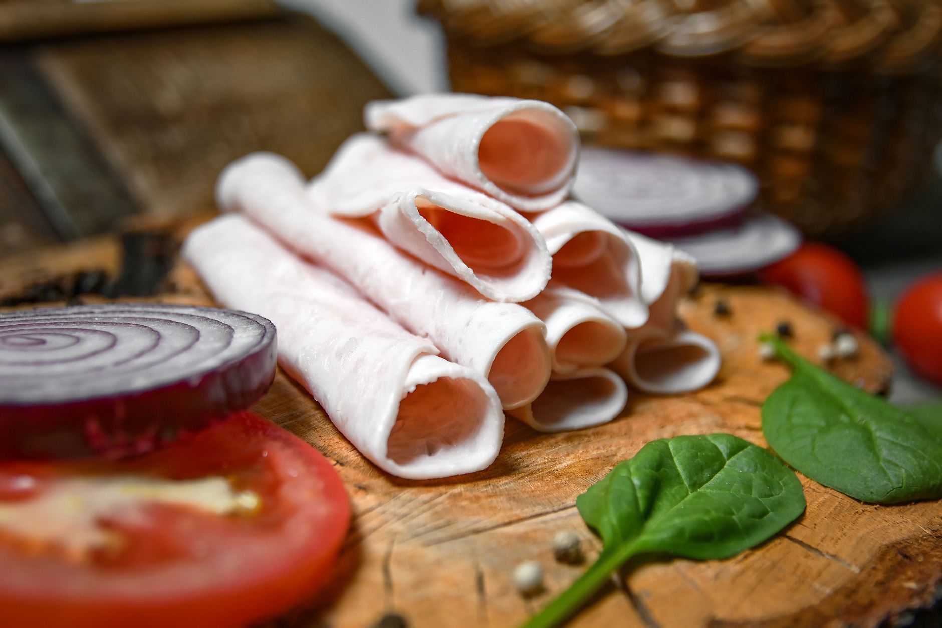 Rolled deli meat slices with onion and tomato