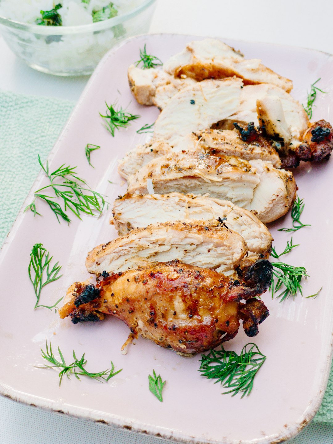 Sliced seasoned grilled chicken on a plate