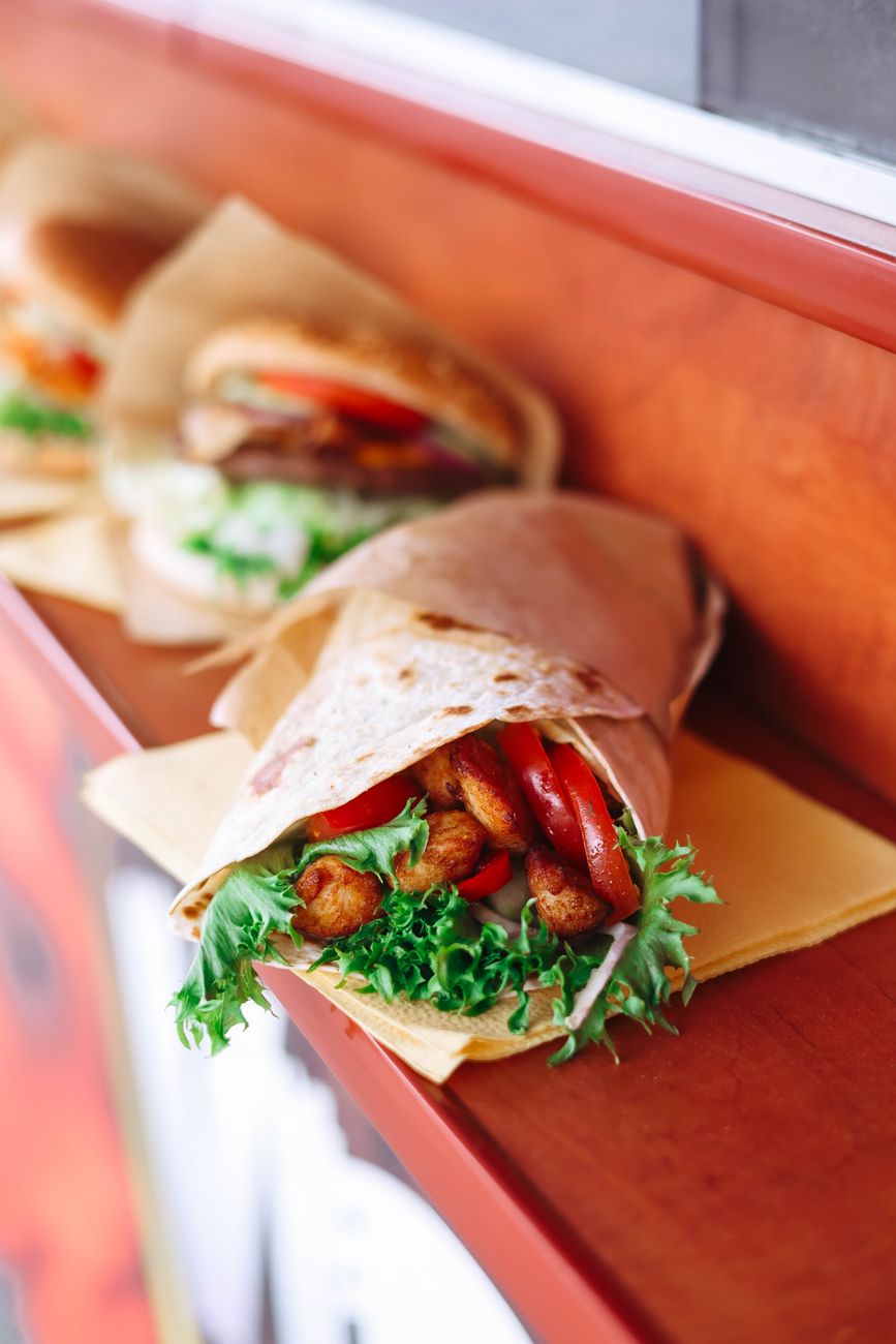 Assorted wraps with fresh ingredients on display