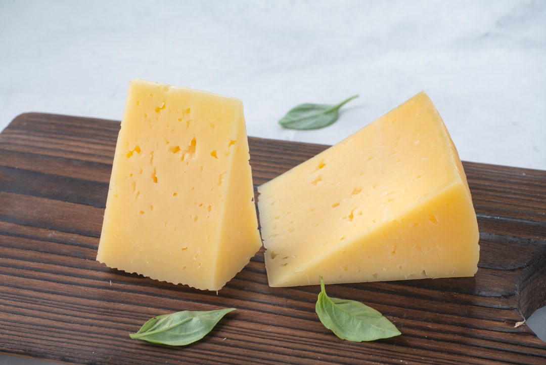 Wedges of provolone cheese on a cutting board