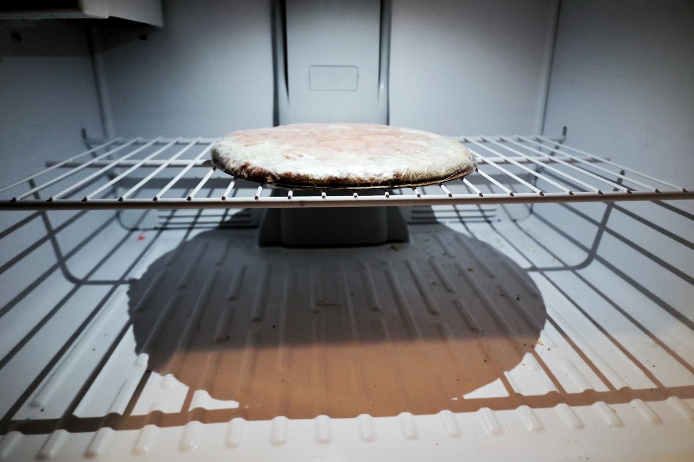 Pizza placed directly on an oven rack for reheating