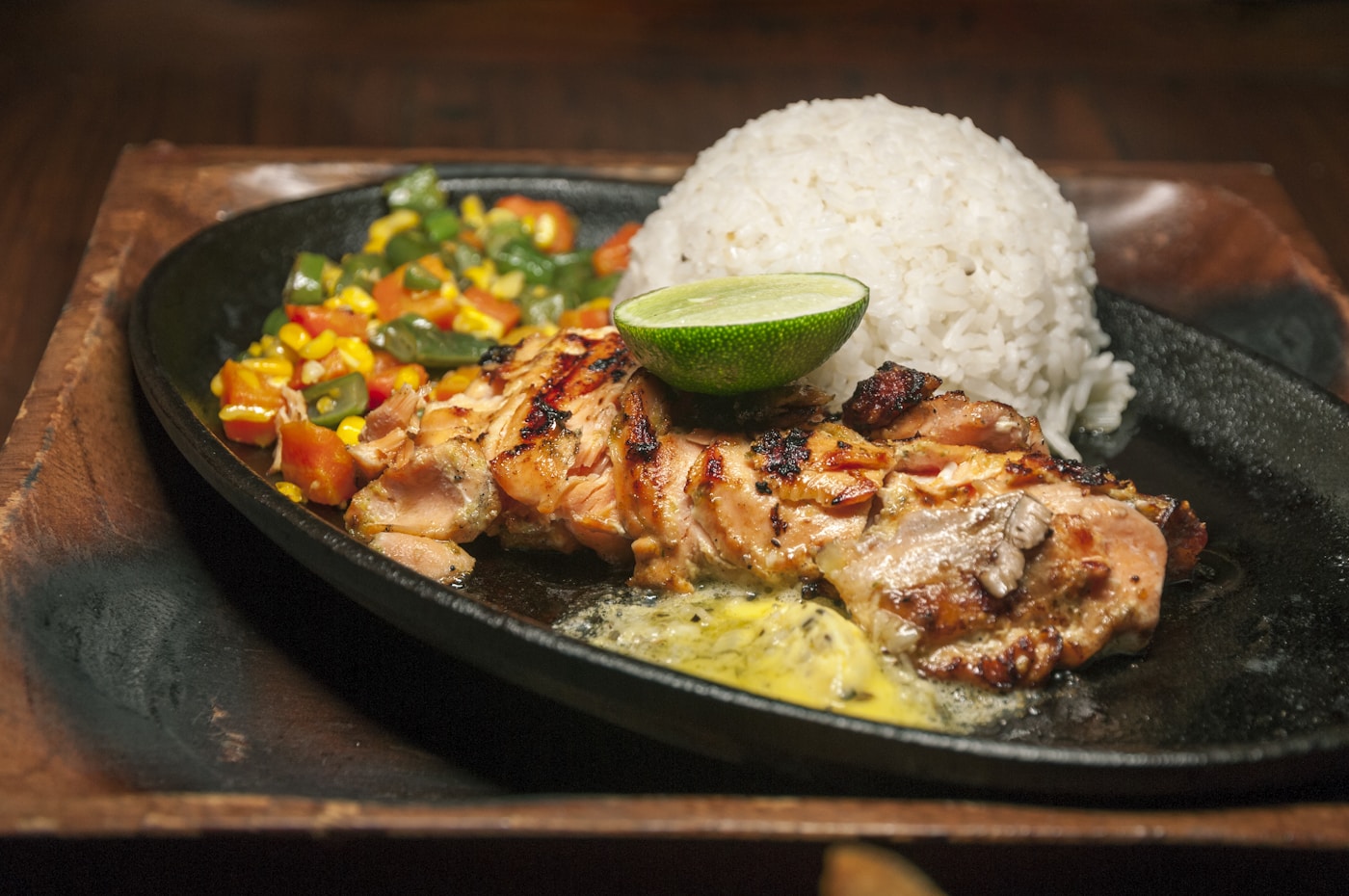 Pollo asado grilled chicken plated with rice and lime