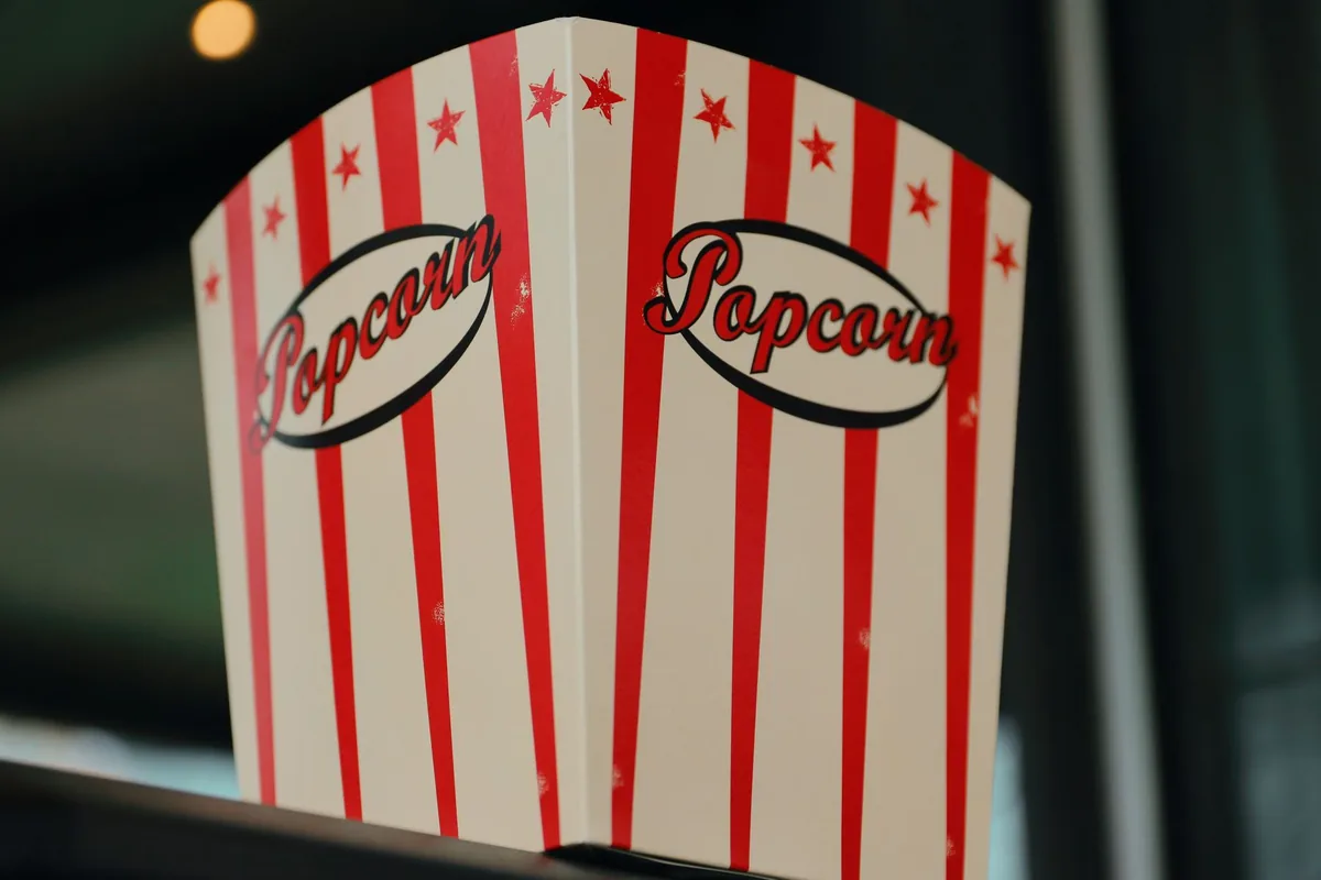 Popcorn spilling from a striped box