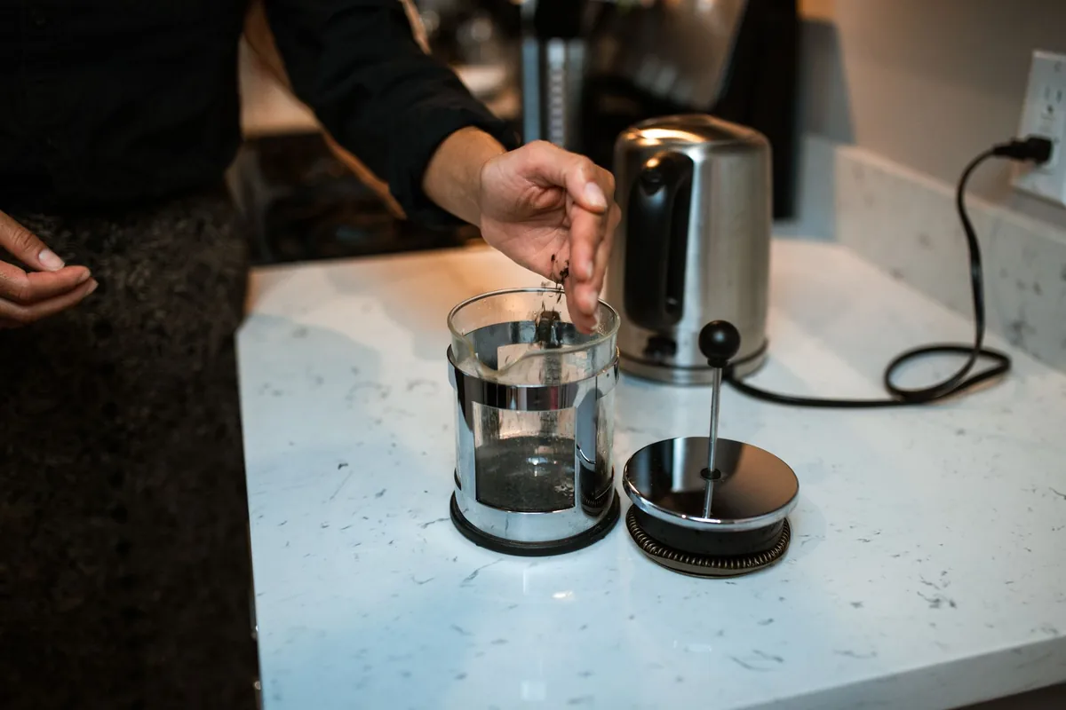 Pressing down a coffee plunger