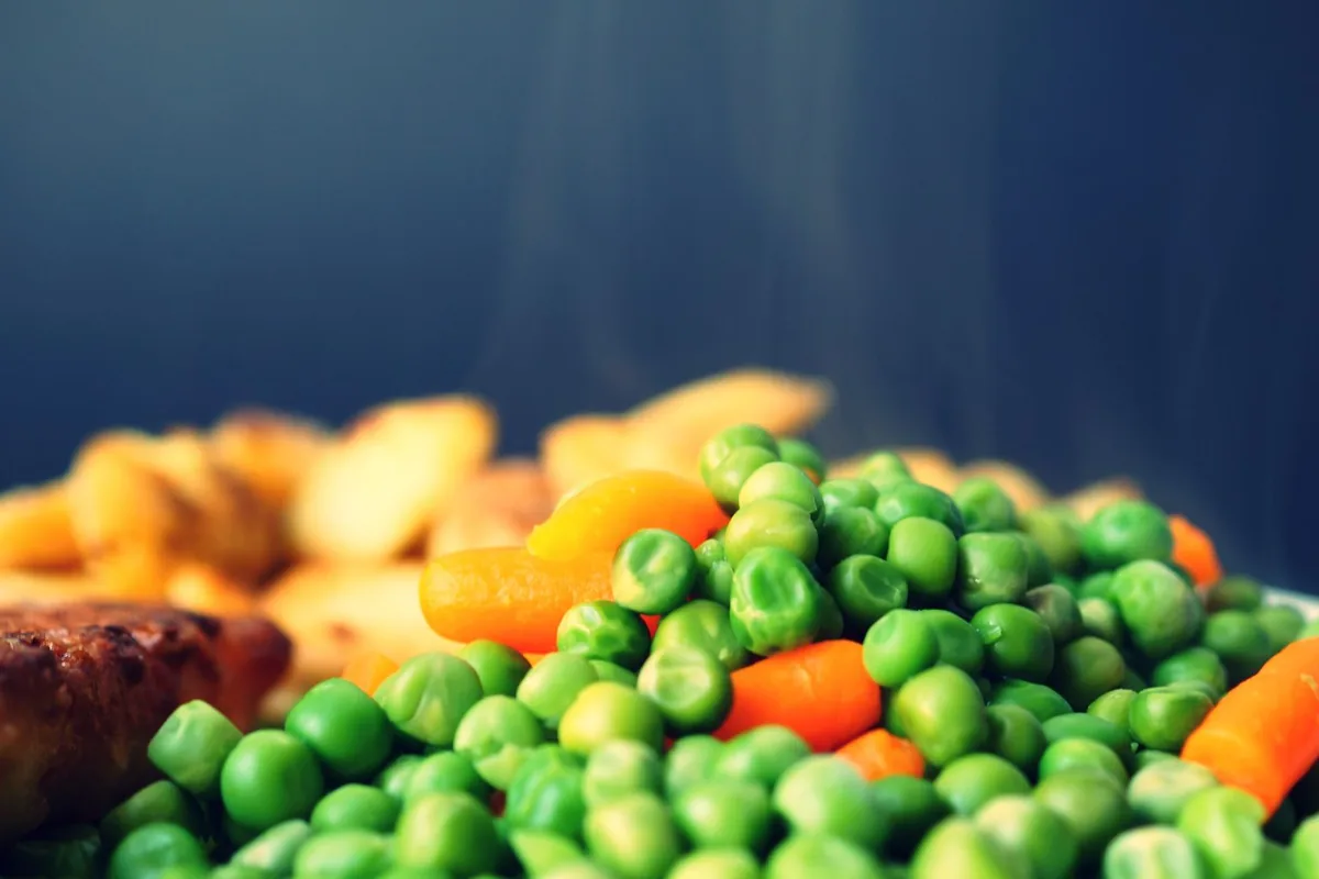 Fresh peas and carrots plated simply