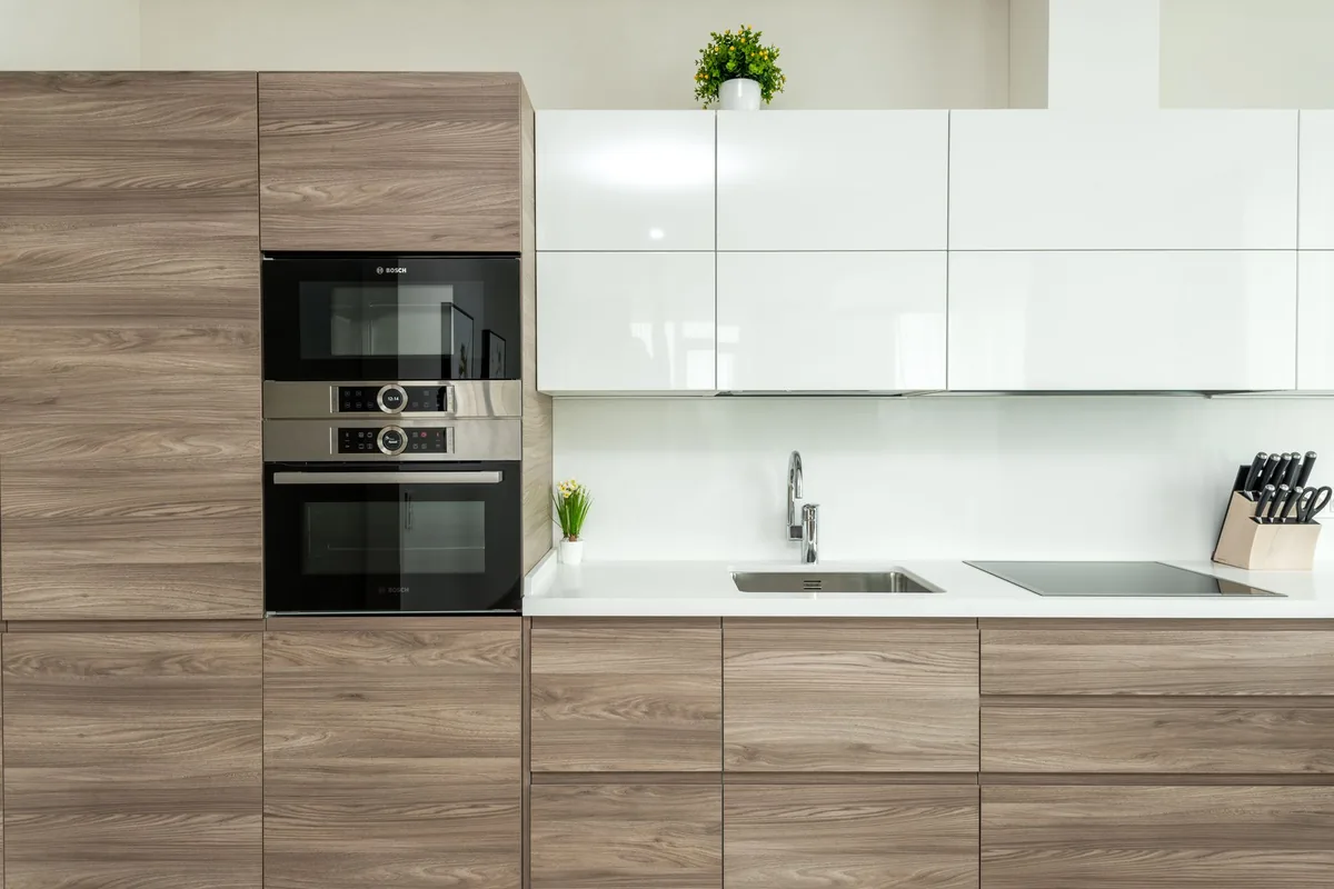 Modern kitchen with white and wooden minimalist cabinets