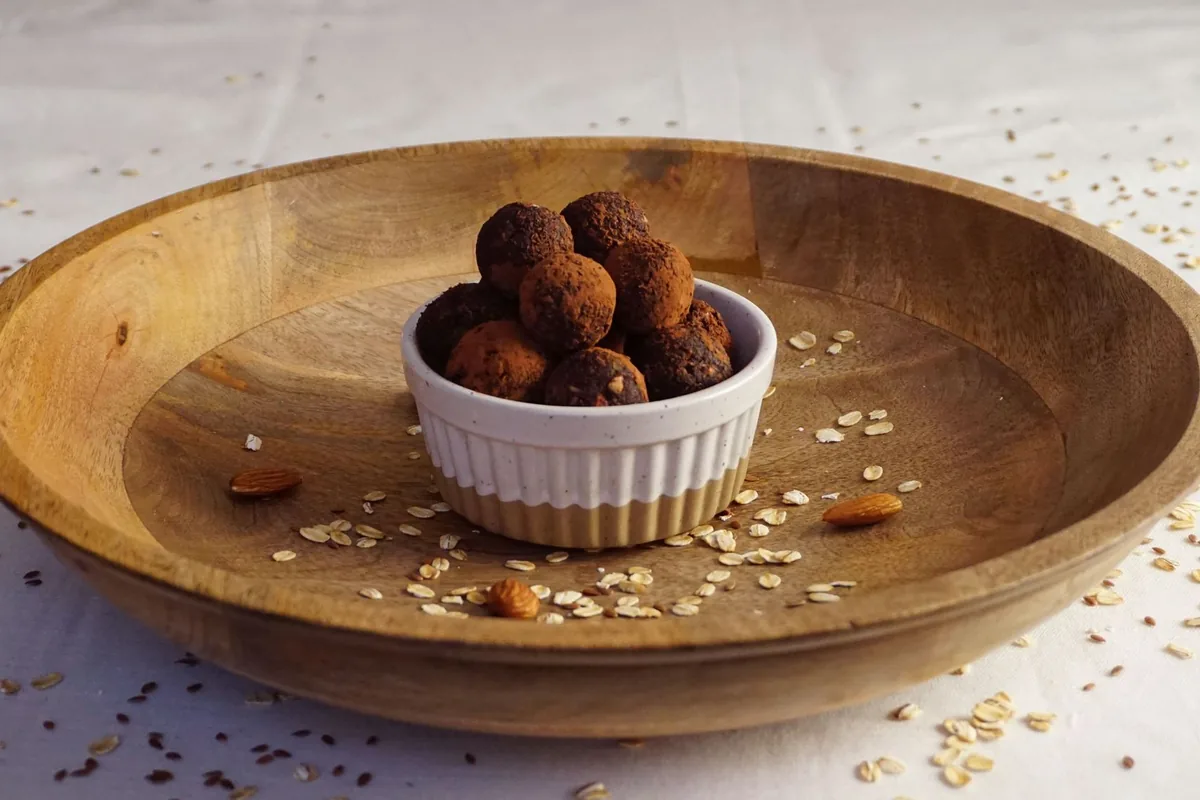 Homemade chocolate energy bites in a wooden bowl