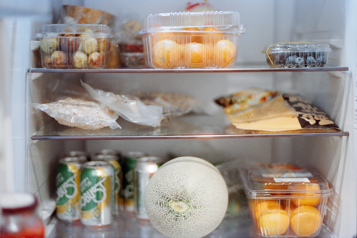 Open refrigerator shelves with food in containers