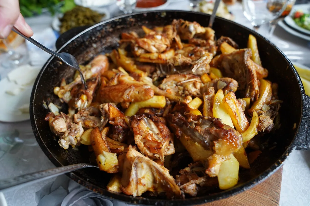 Roasted chicken and potatoes in a large skillet
