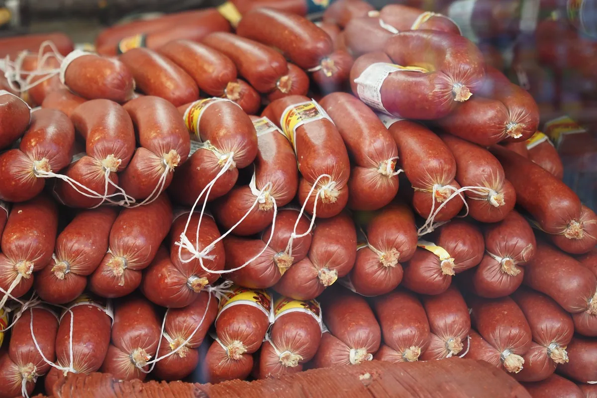 Sausages being linked