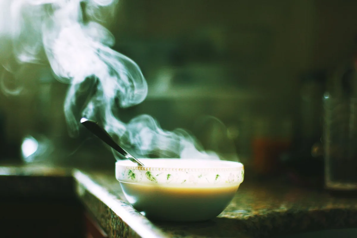 Steaming bowl of soup on a kitchen counter