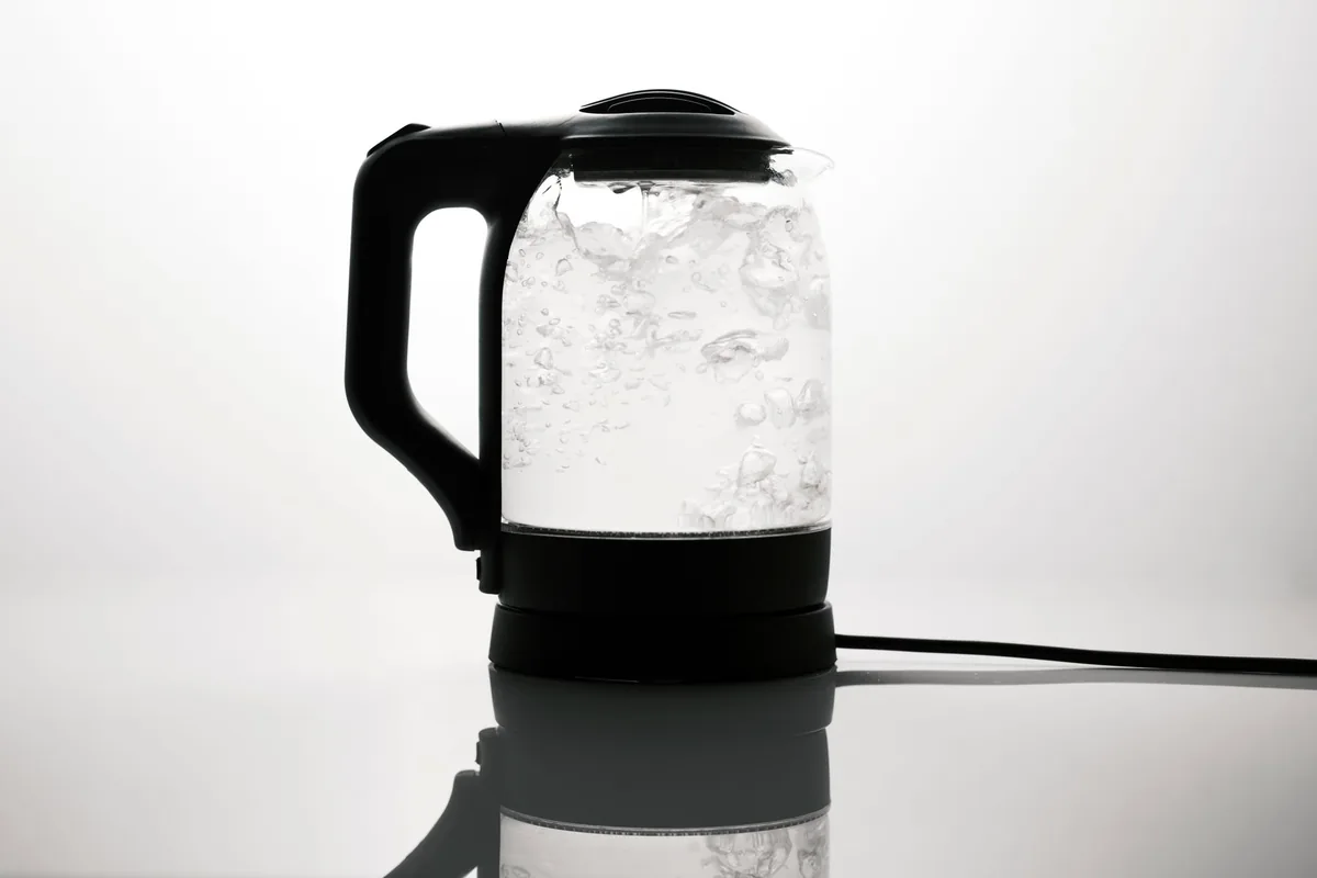 A sleek electric kettle boiling water