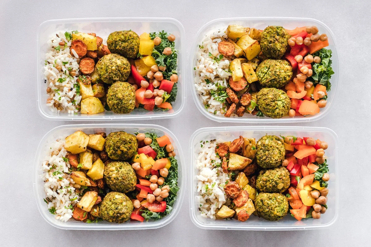 Colourful meal prep containers with chickpeas, rice and vegetables