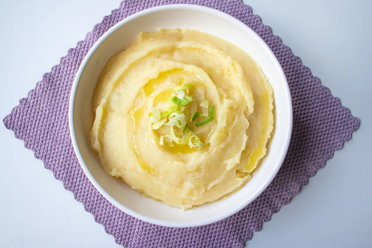 Creamy mashed potatoes garnished with scallions