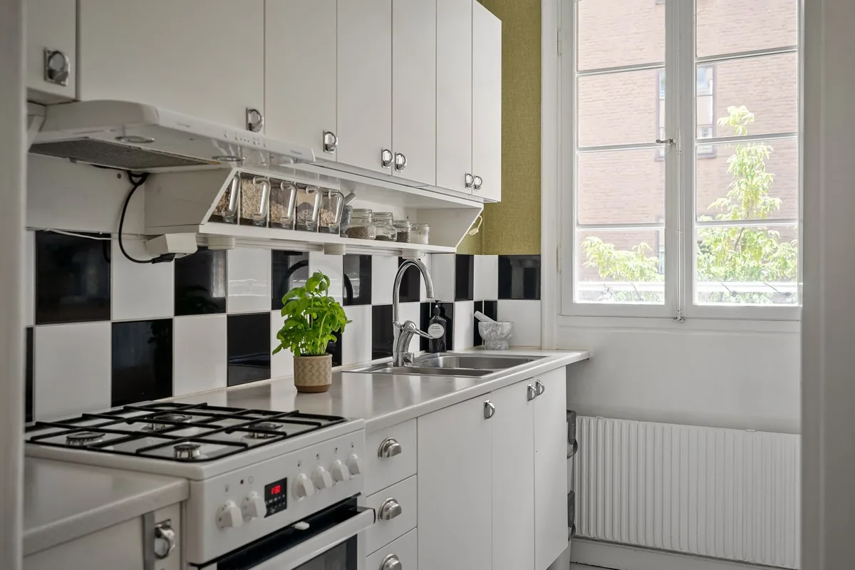 Compact white kitchen with limited counter space