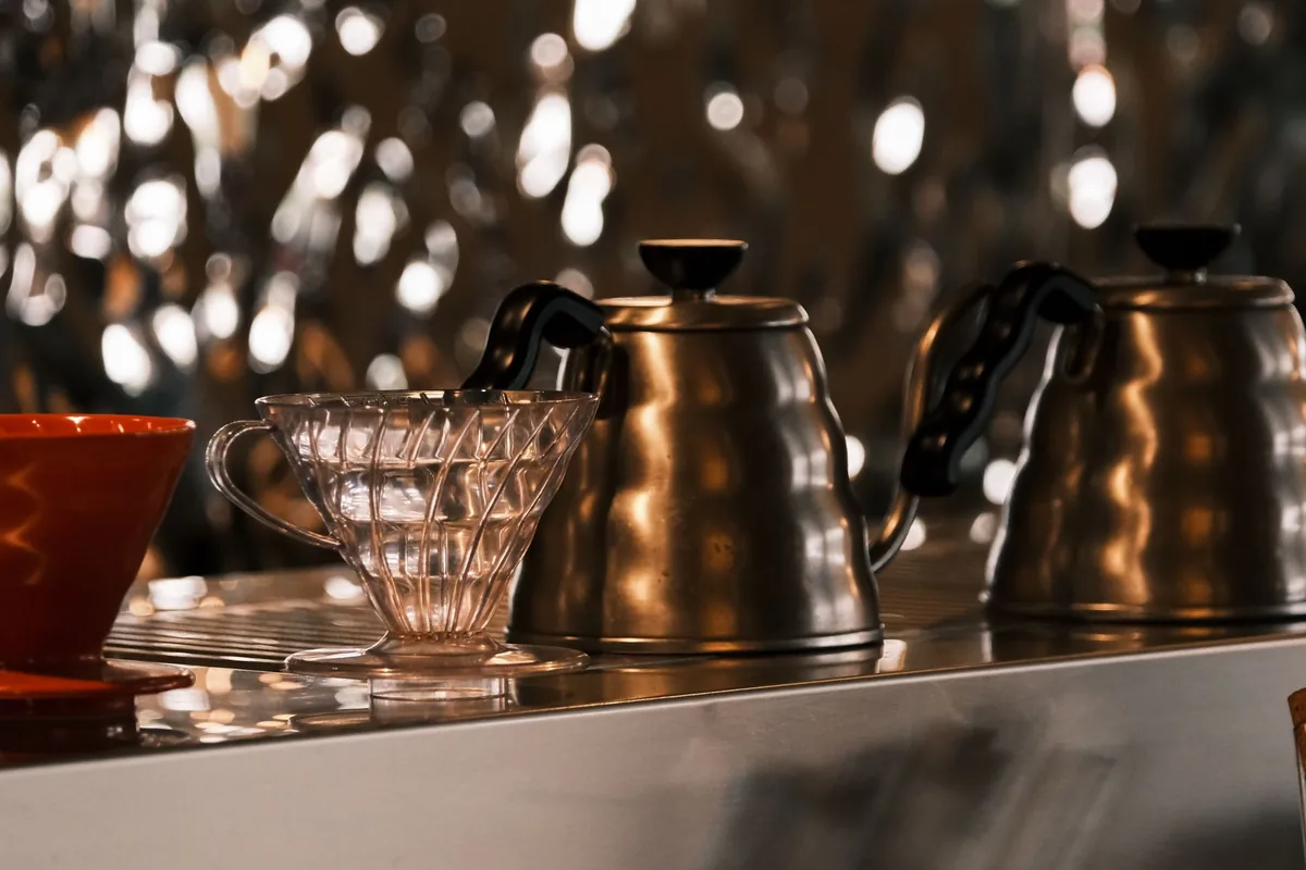 Stainless steel kettles in a modern cafe