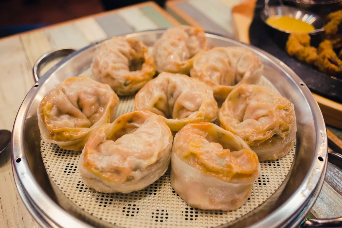 Steamed dumplings served on a tray