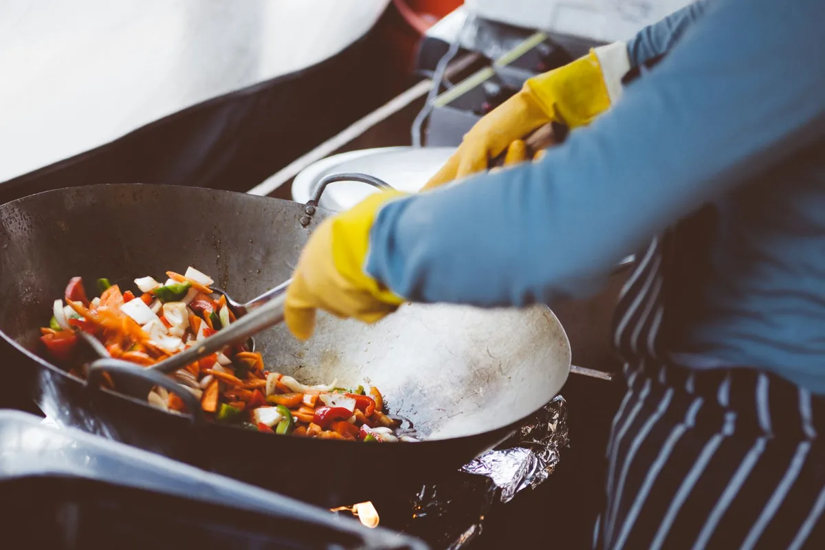 Stir-frying vegetables over a flame