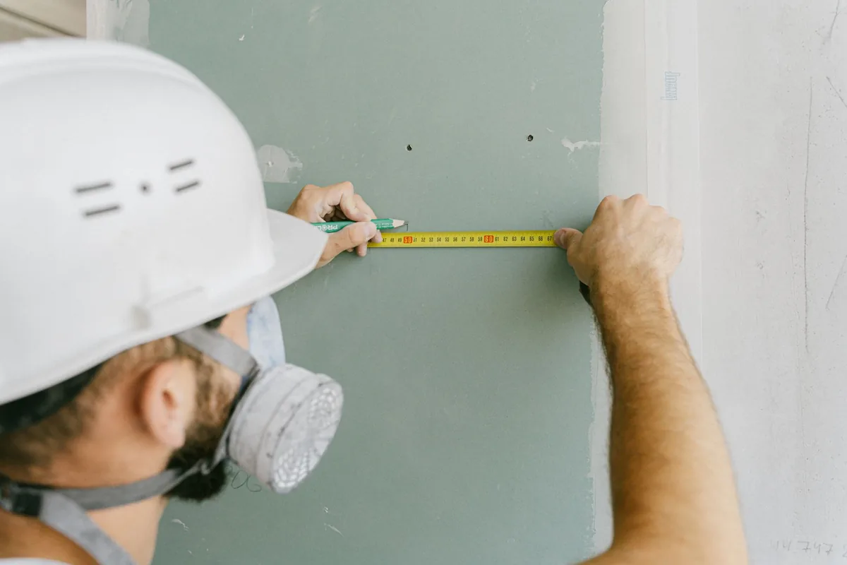 Tape measure extended against a kitchen wall