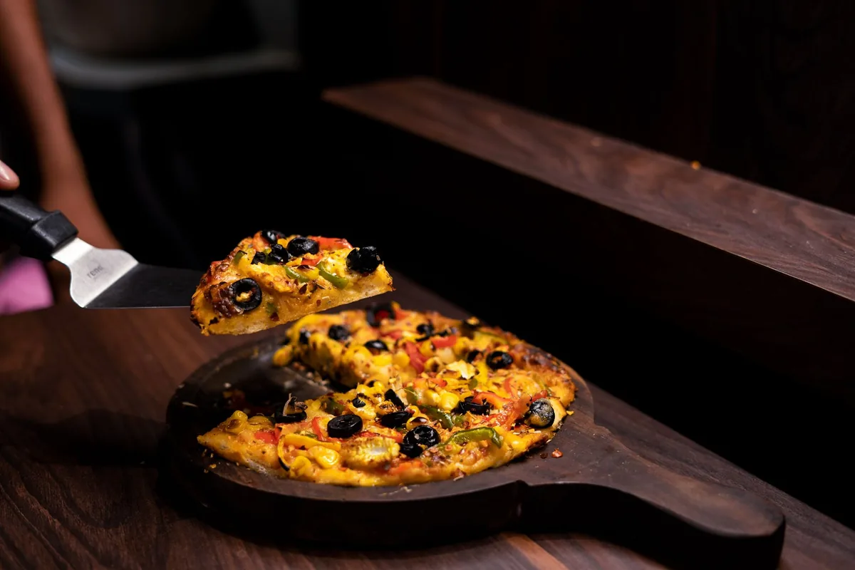Homemade vegetable pizza with olives and cheese