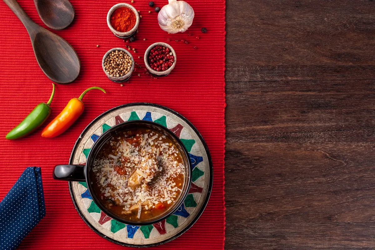 Hot spicy soup garnished with cheese