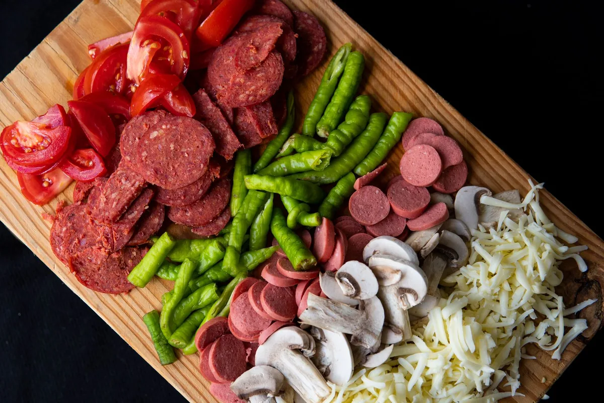 Meat and vegetables with grated cheese ready to cook