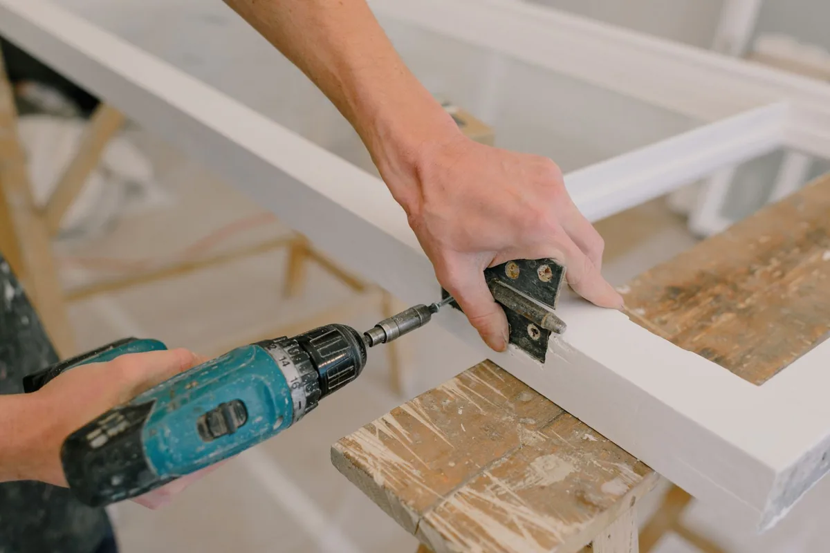 Person using a screwdriver during a kitchen installation