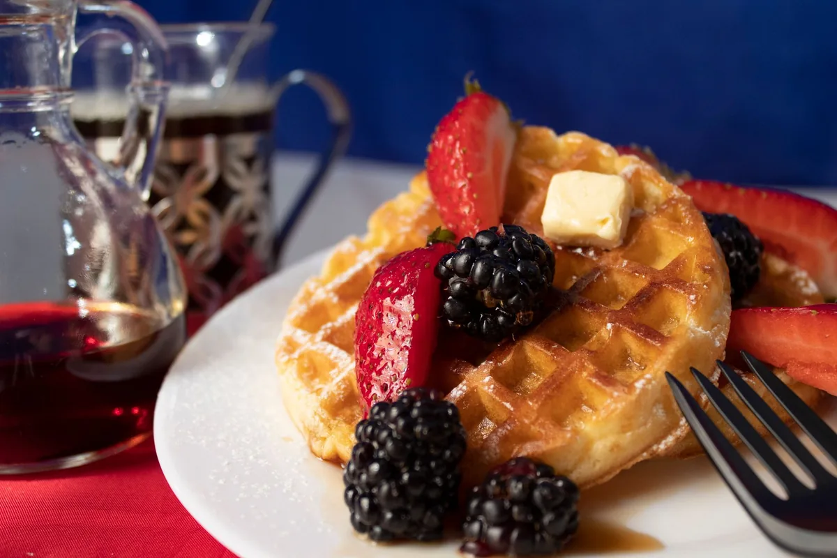 Waffles with berries and syrup