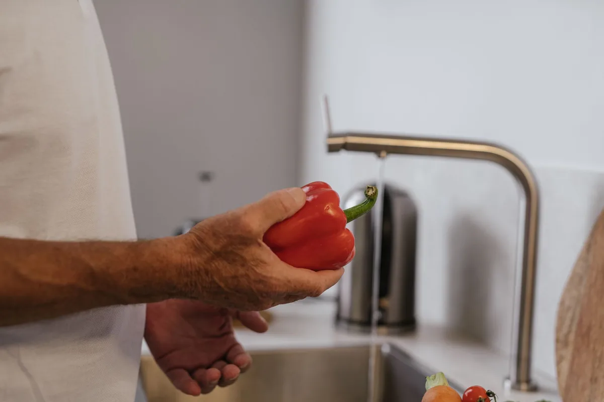 Washing vegetables under a tap