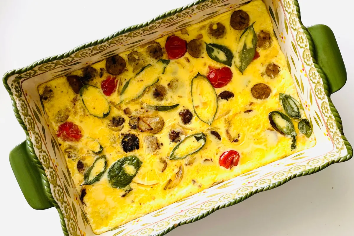 A vegetable frittata in a green rectangular ceramic dish