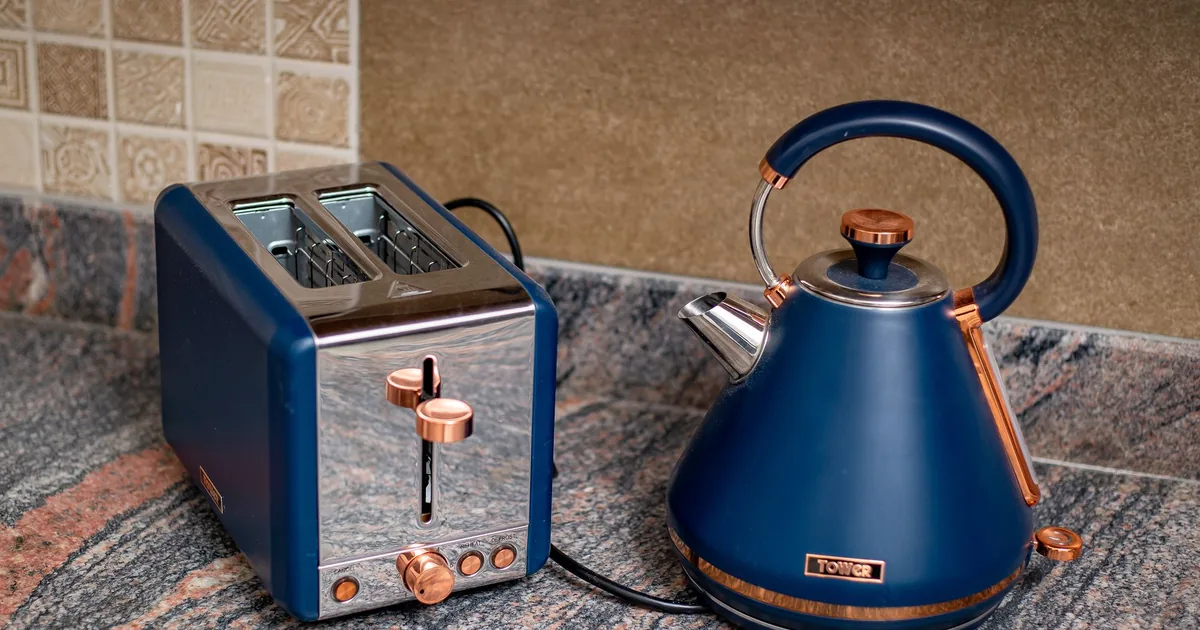 A blue toaster and matching kettle on a granite counter
