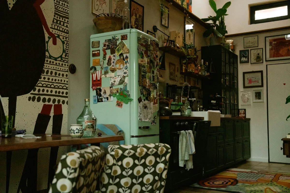An eclectic kitchen with a mint fridge and patterned decor
