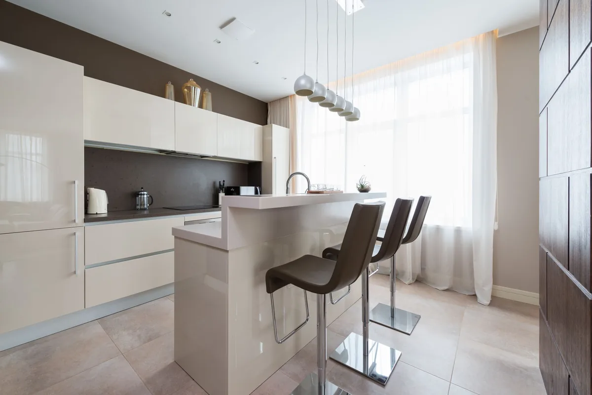 A modern kitchen with an island and bar stools