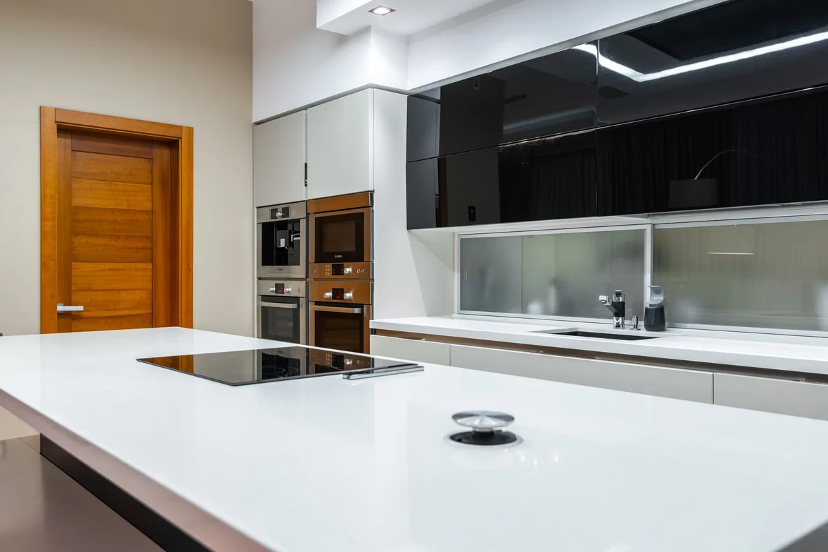 A modern kitchen island with a black cooktop
