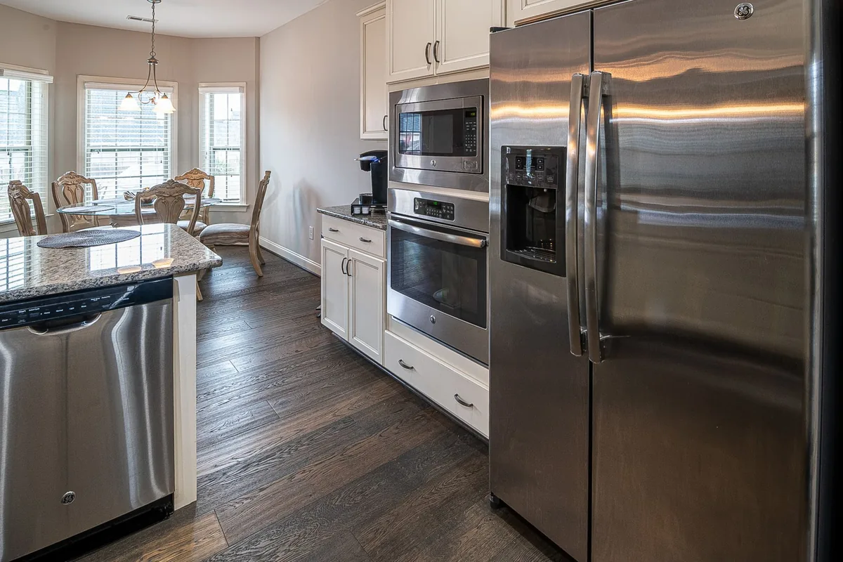 A clean, bright kitchen worktop with a small appliance against a white tiled wall